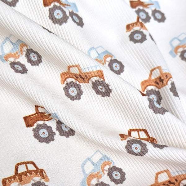 Rippenjersey mit Monstertruck Motiv auf hellblauem Hintergrund – weicher Ribjersey Kinderstoff mit Polizeiautos als Detailaufnahme