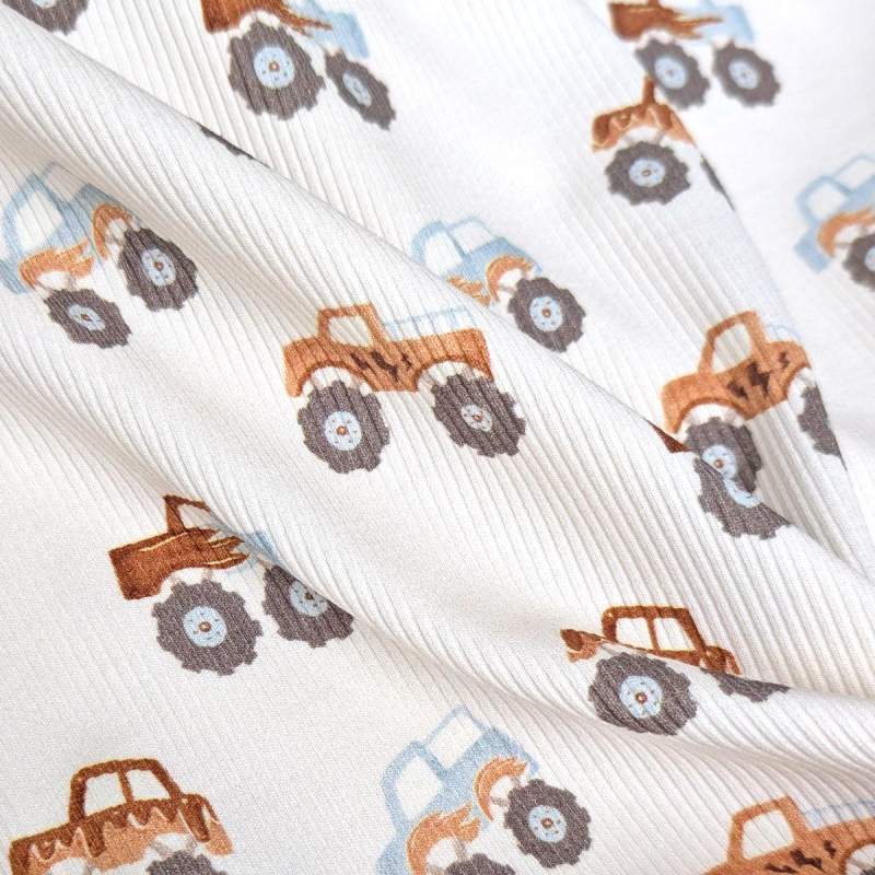 Rippenjersey mit Monstertruck Motiv auf hellblauem Hintergrund – weicher Ribjersey Kinderstoff mit Polizeiautos als Detailaufnahme